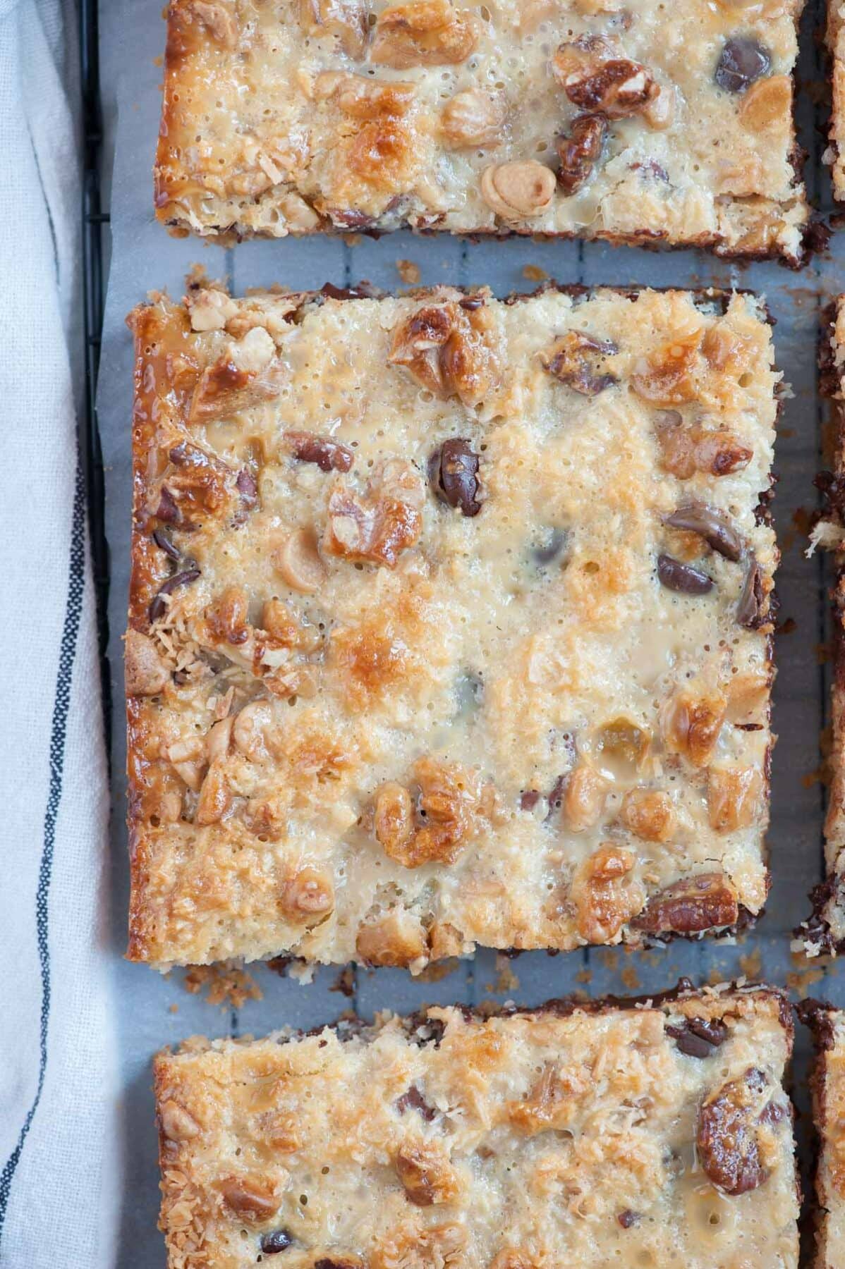 A close up photo of 7-layer magic bars on a cooling rack.