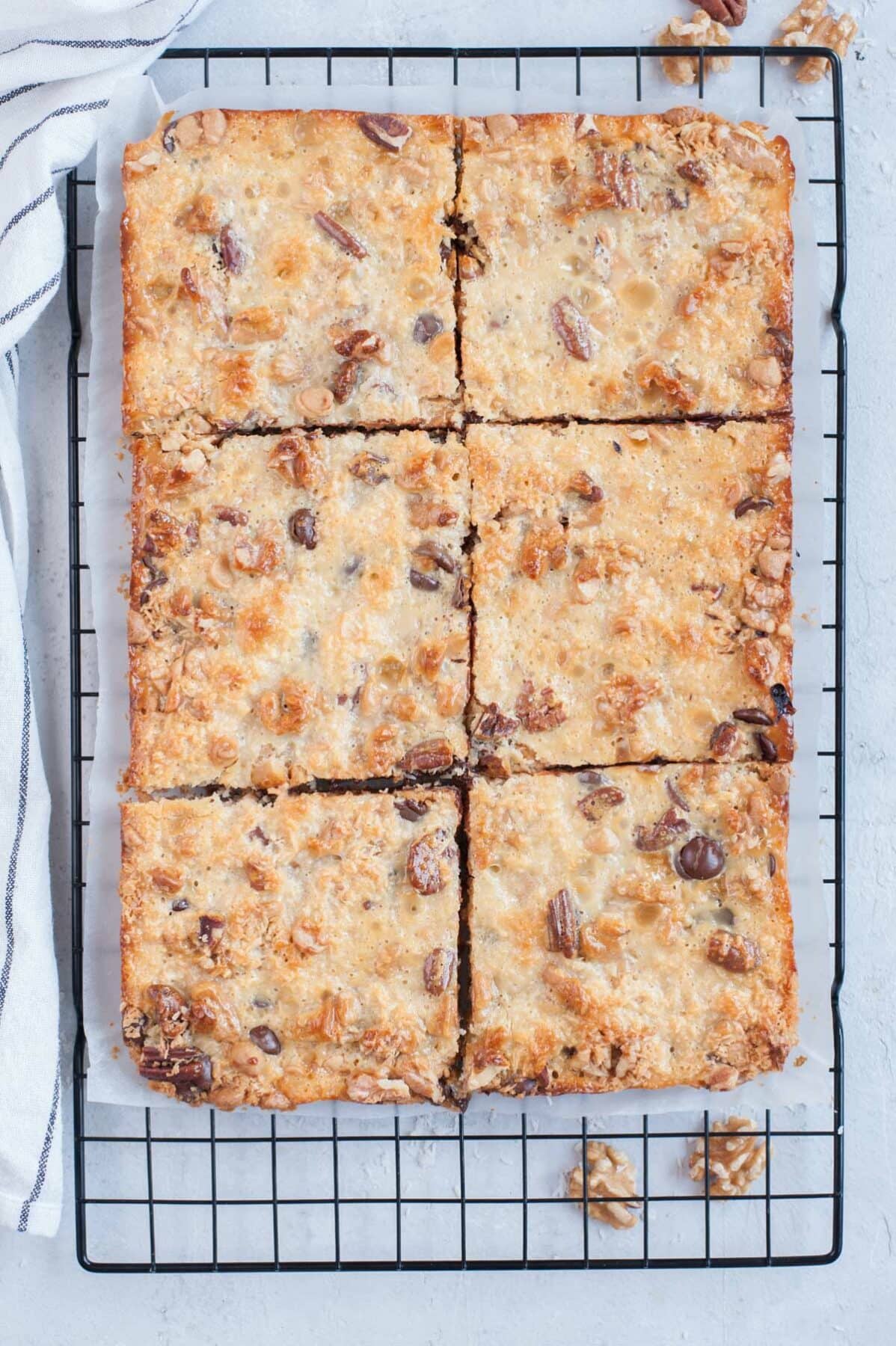 7-layer magic bars divided into squares on a cooling rack.