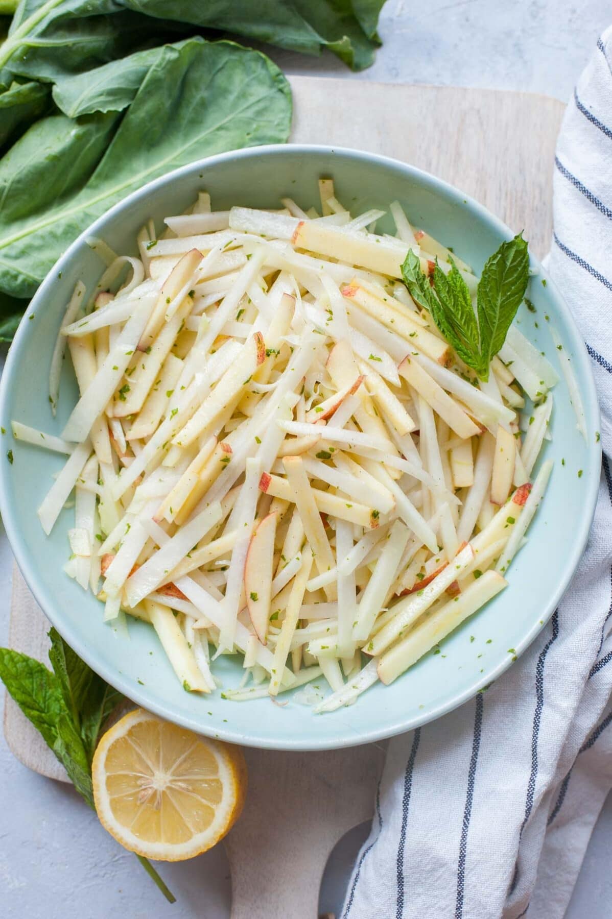 Kohlrabi apple slaw in a green bowl.