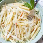 Kohlrabi apple slaw on a green bowl.