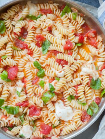 Hot Caprese pasta in a frying pan.