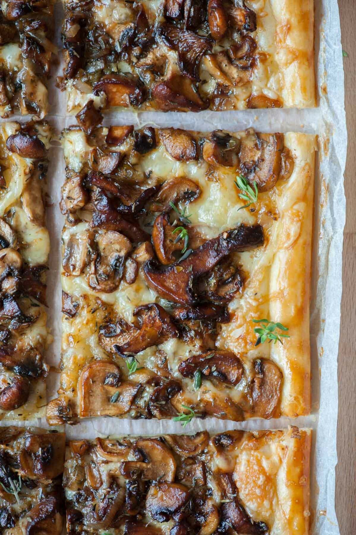 A close up picture of mushroom tart cut into squares.