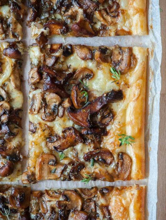 A close up photo of puff pastry mushroom tart.