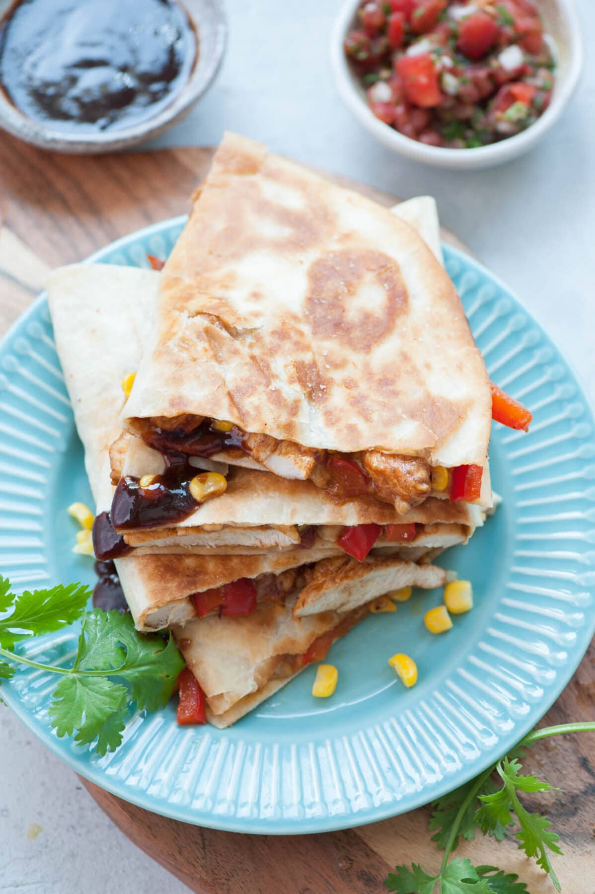 A stack of BBQ Chicken Quesadillas on a blue plate.