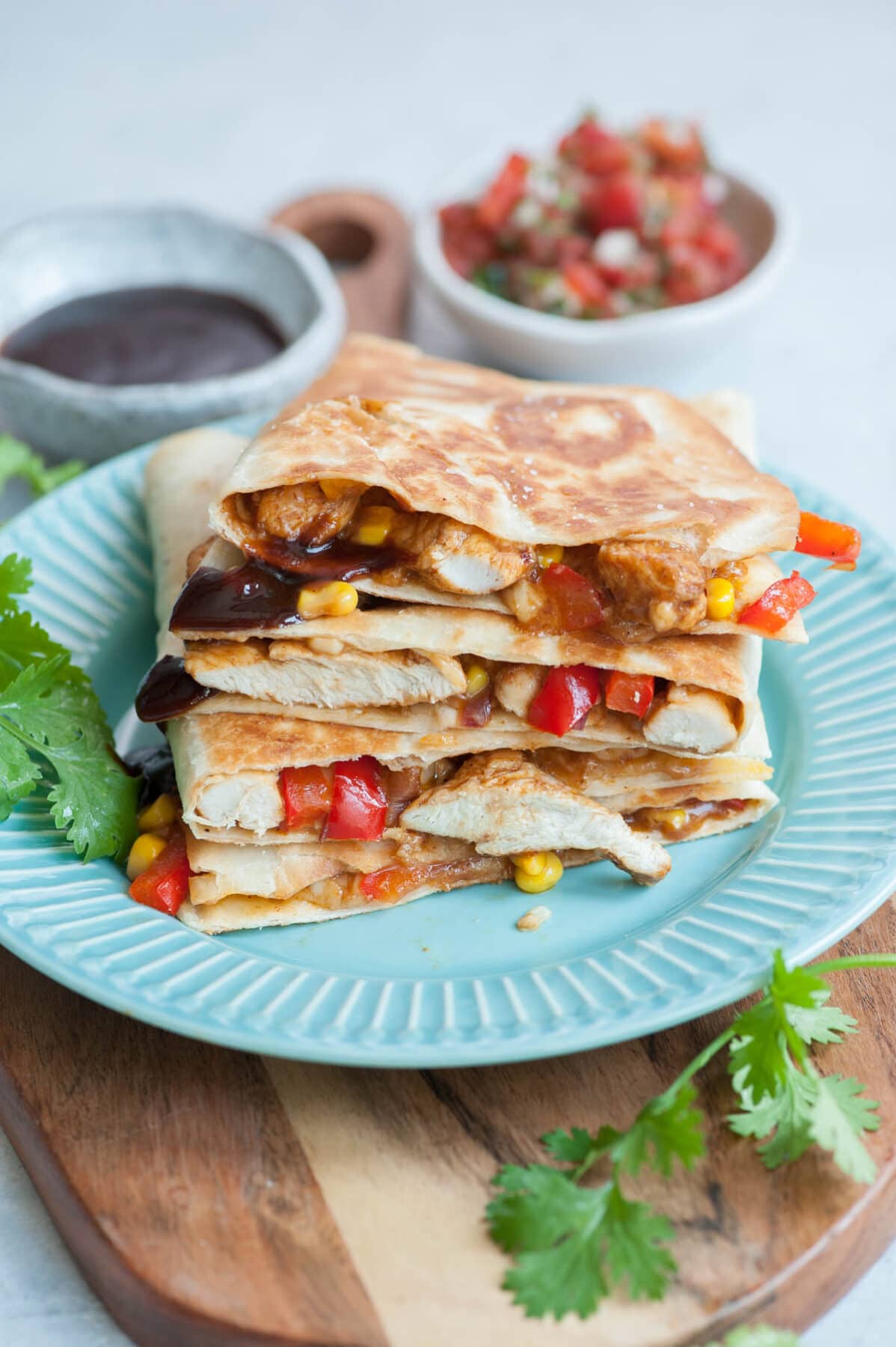 Bbq chicken quesadillas on a blue plate.