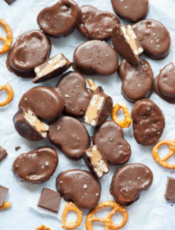 Chocolate peanut butter pretzels on a piece of parchment paper.