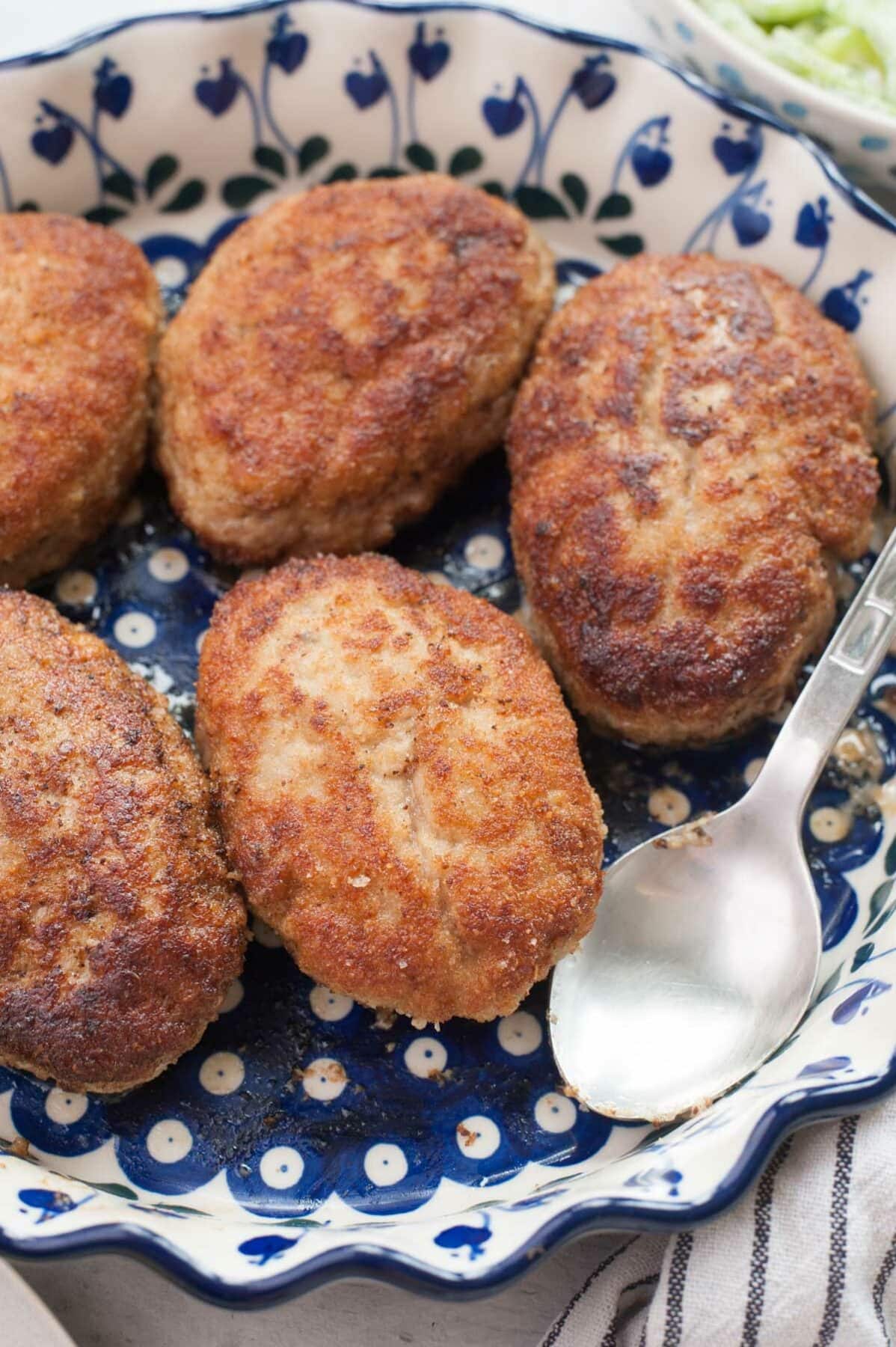 Kotlety mielone (Polish meat patties) in a white-blue baking dish.