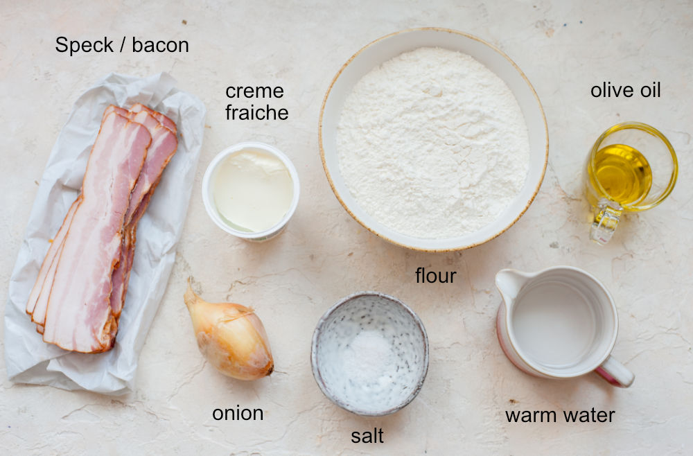 Labeled ingredients needed to prepare Flammkuchen.