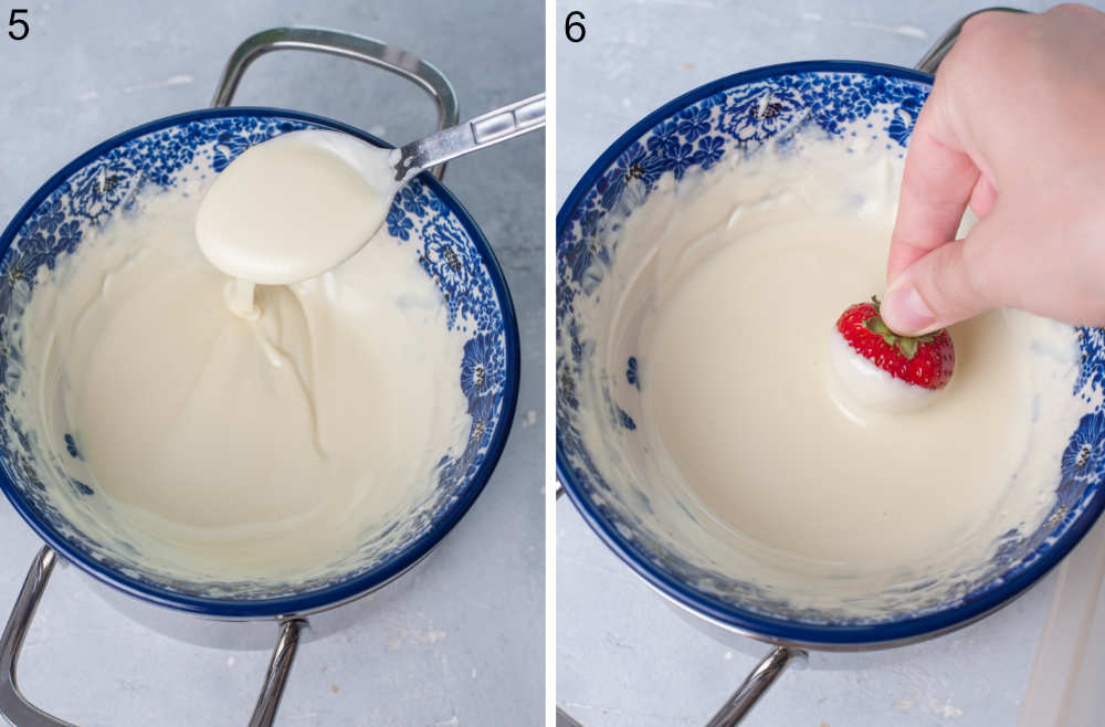 Melted white chocolate in a bowl. A strawberry is being dipped into melted white chocolate.