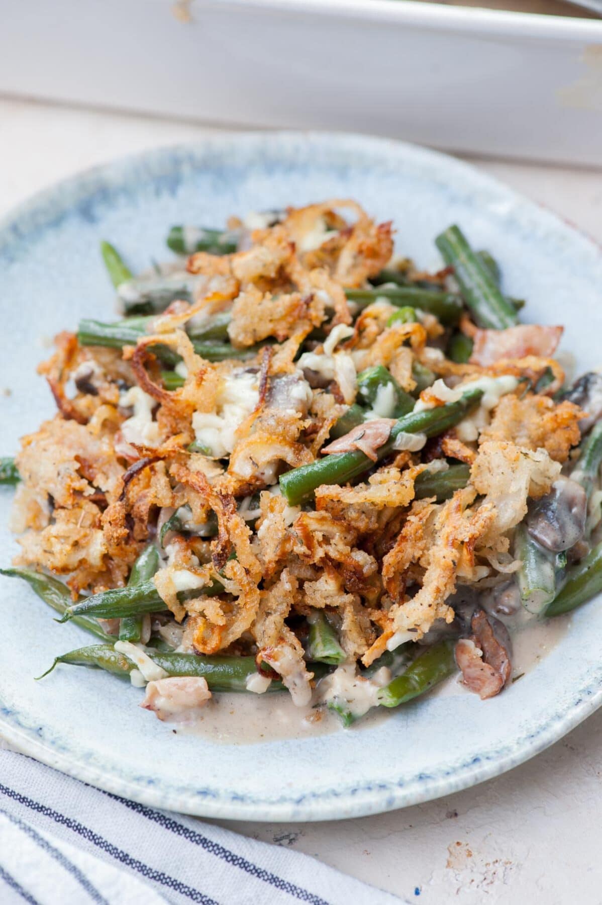 Green bean casserole on a green plate.