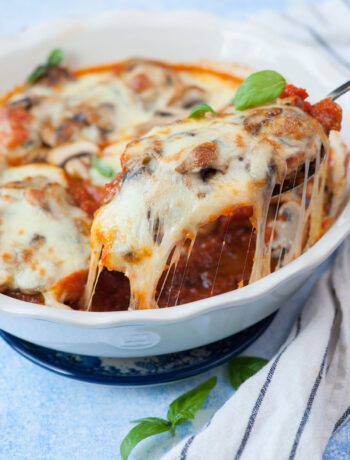 Mozzarella chicken in a white baking dish.