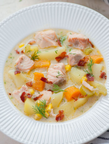 Salmon chowder in a white plate.
