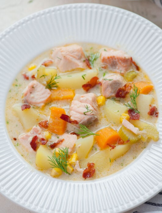 Salmon chowder in a white plate.