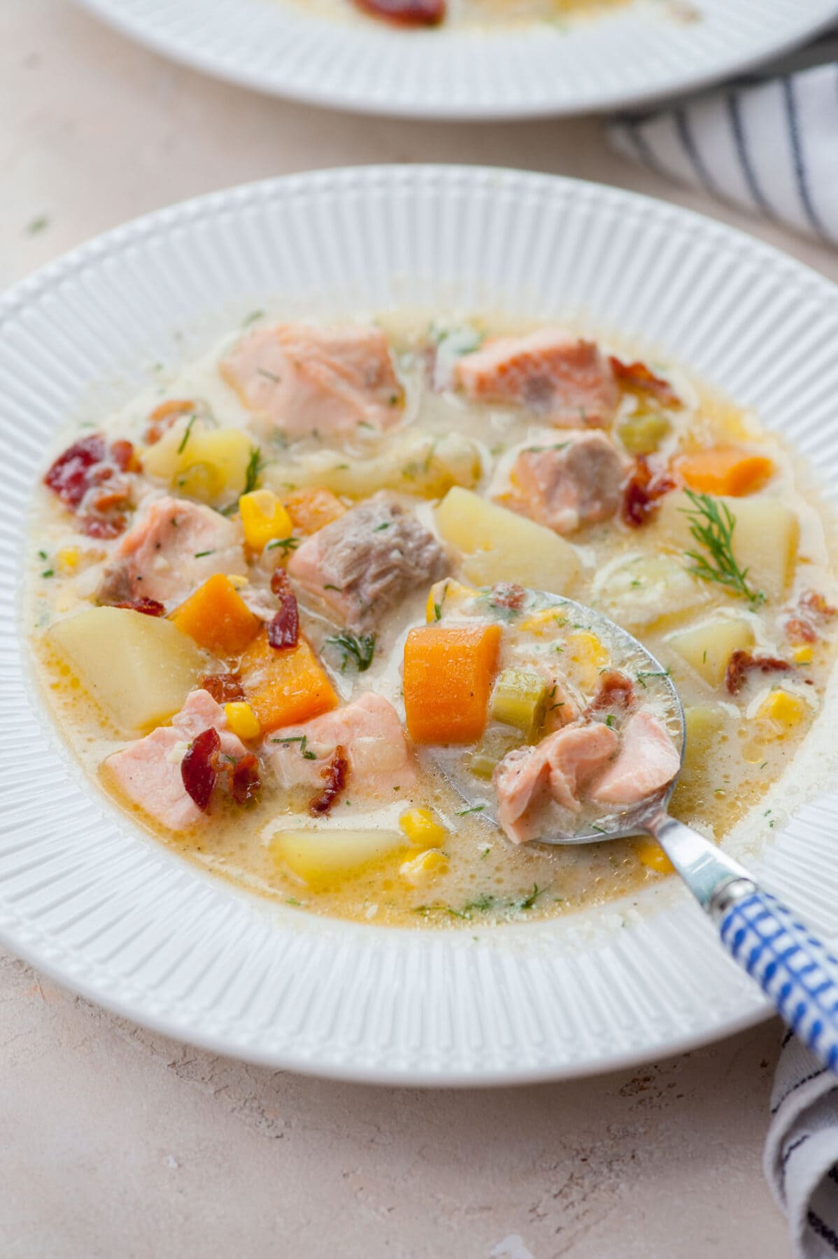 Salmon chowder in a white plate.