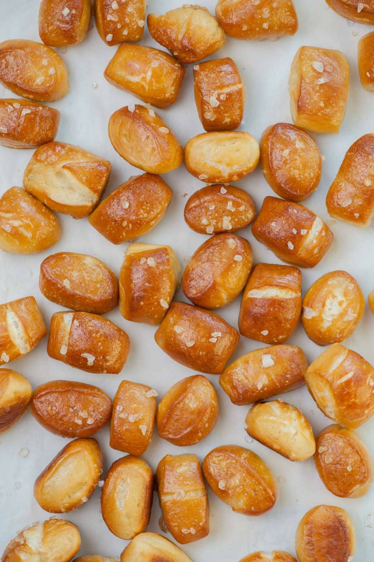 Soft pretzel bites on a piece of parchment paper.