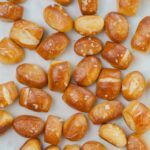 Soft pretzel bites on a piece of parchment paper.