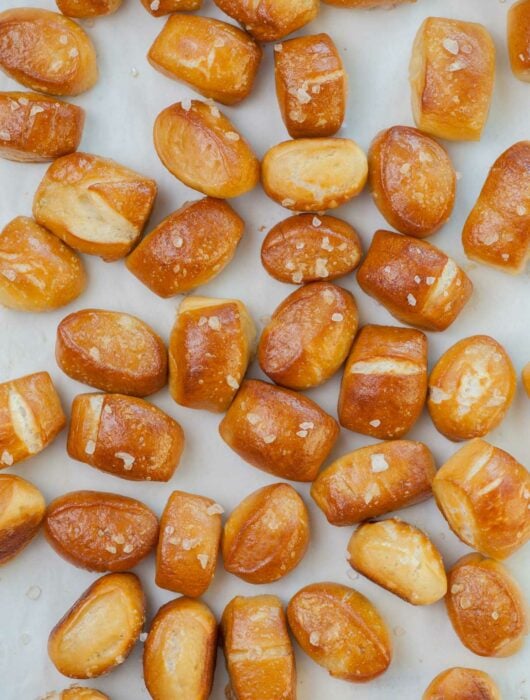 Soft pretzel bites on a piece of parchment paper.