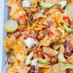 Chicken fajita nachos on a baking sheet.