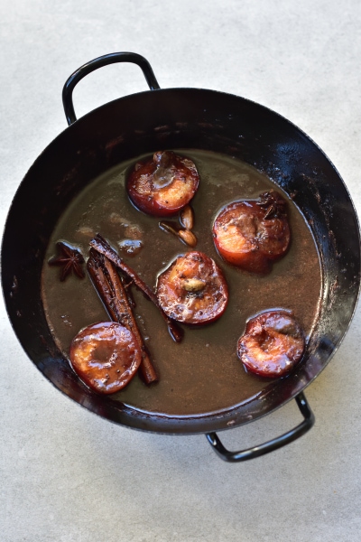 Plum sauce in a black pan.