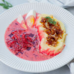 Polish borscht soup served with mashed potatoes, onions, and bacon.