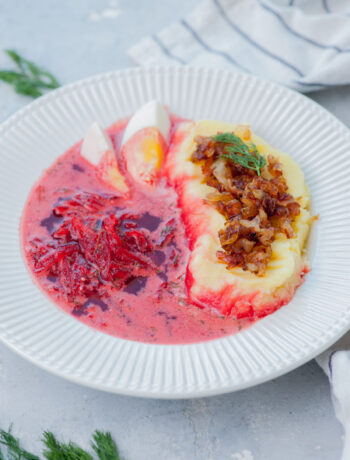 Polish borscht soup served with mashed potatoes, onions, and bacon.