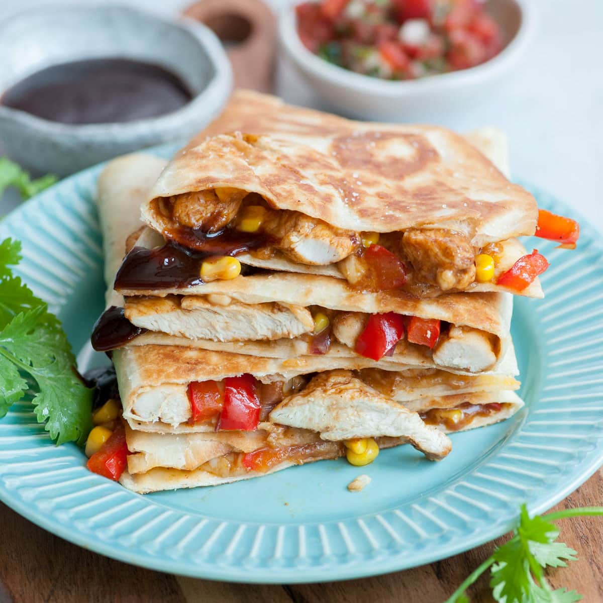 BBQ chicken quesadillas on a blue plate.