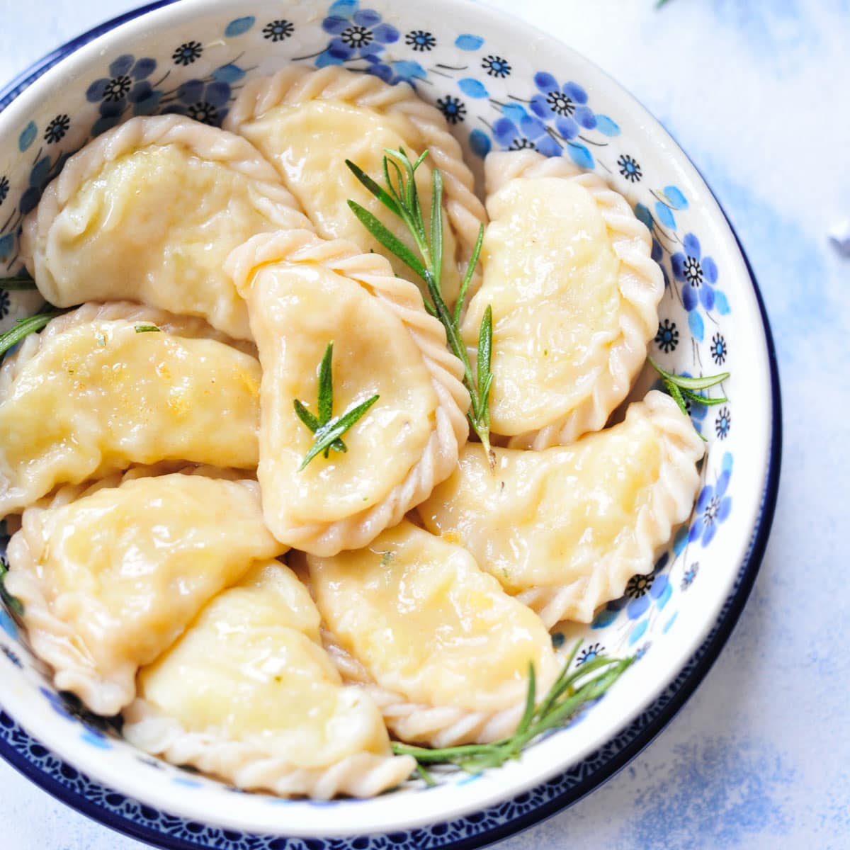 Pierogi in a blue bowl.