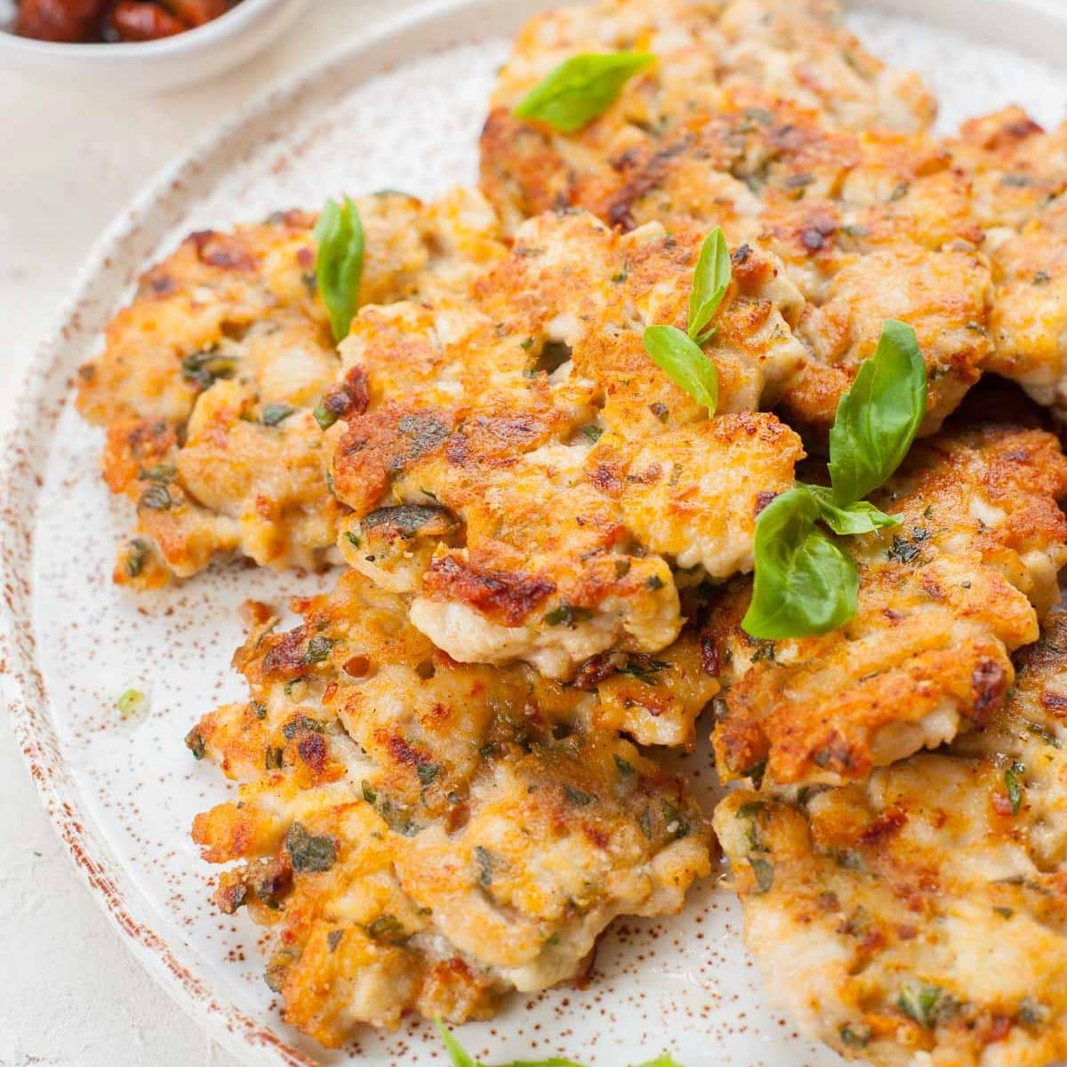 Chicken fritters on a white plate.