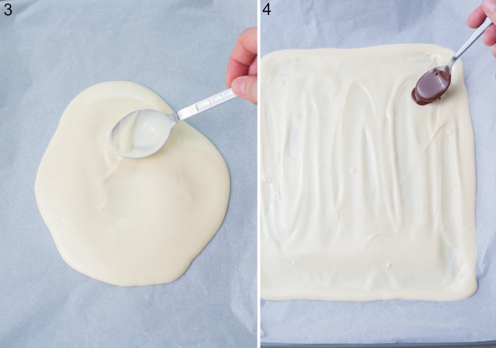 Melted white chocolate is being spread with a spoon on a piece of parchment paper. Bittersweet chocolate is being spooned over the white chocolate.