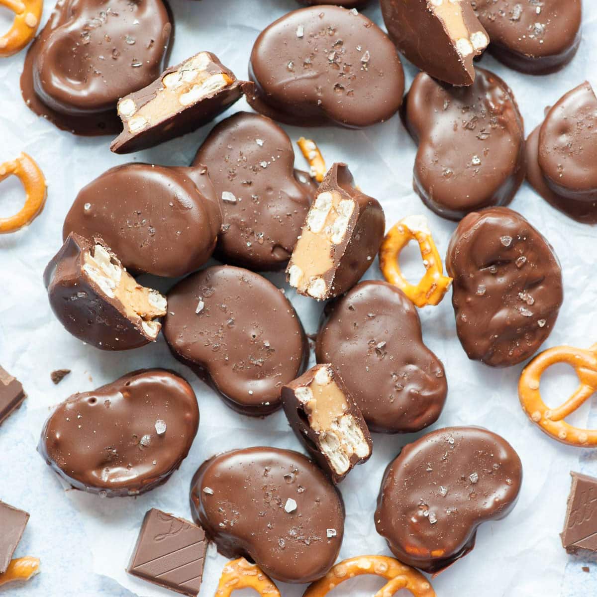 Chocolate peanut butter pretzel bites on a piece of parchment paper.