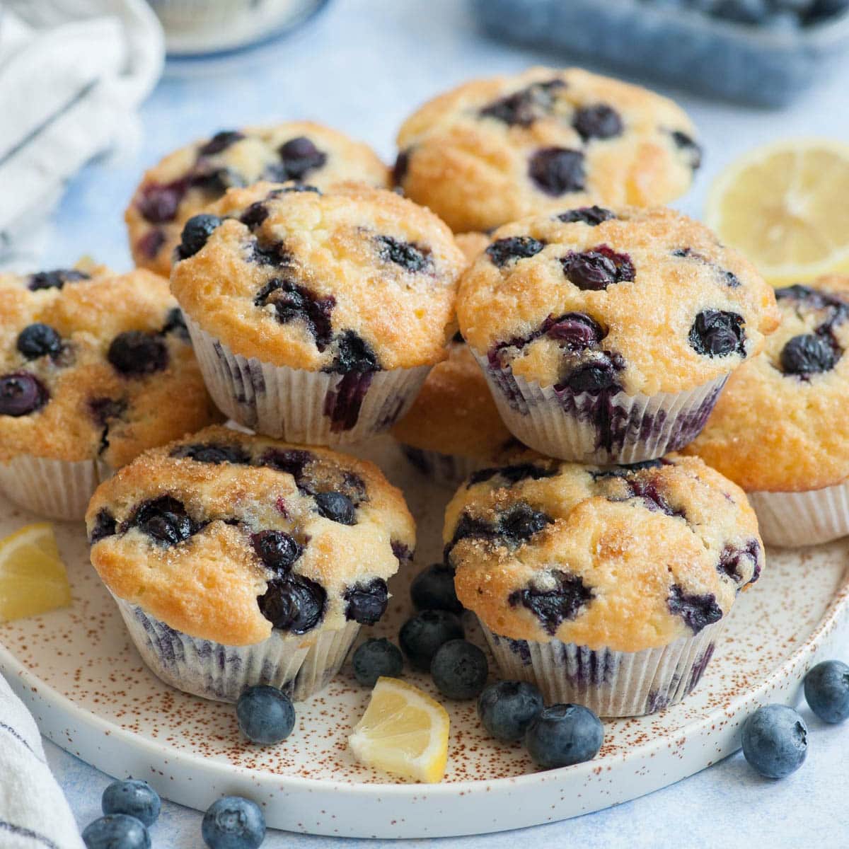 Blueberry muffins on a white plate.