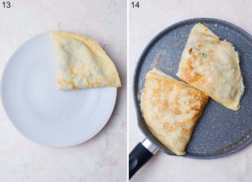 A crepe folded into a triangle on a plate. Crepes are being pan-fried in a black pan.