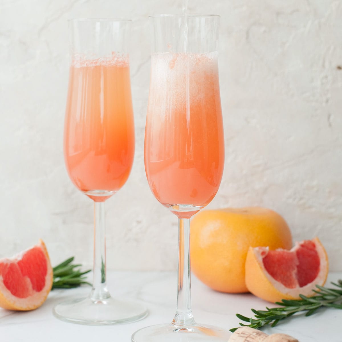Grapefruit mimosa in champagne glasses.