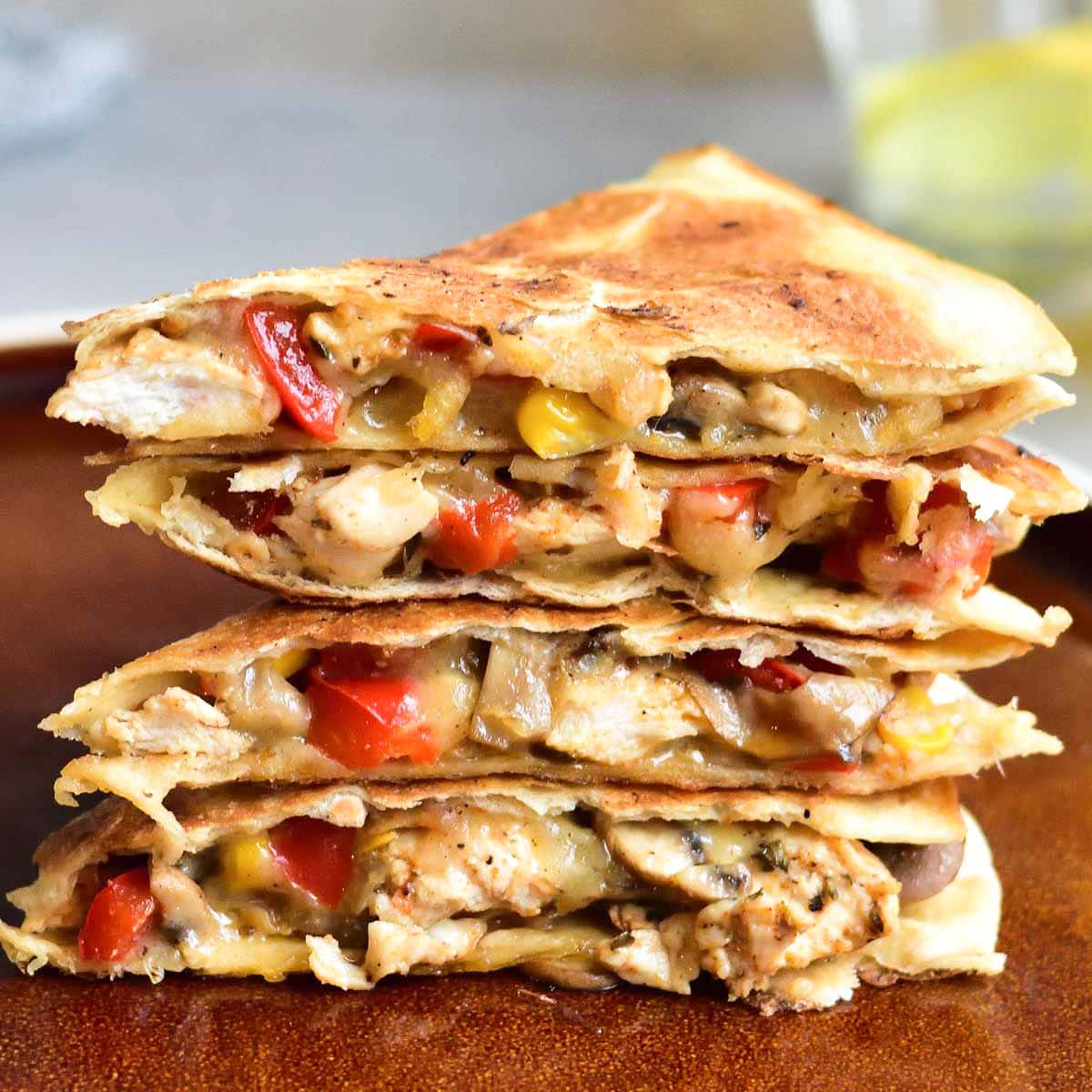 Chicken quesadillas on a brown plate.