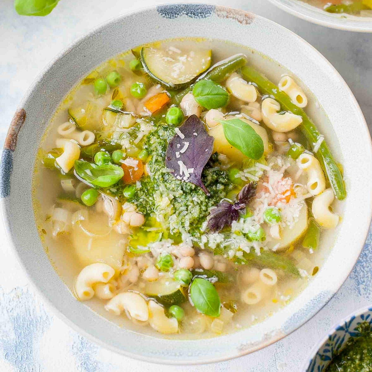 Pistou soup in a blue soup bowl.