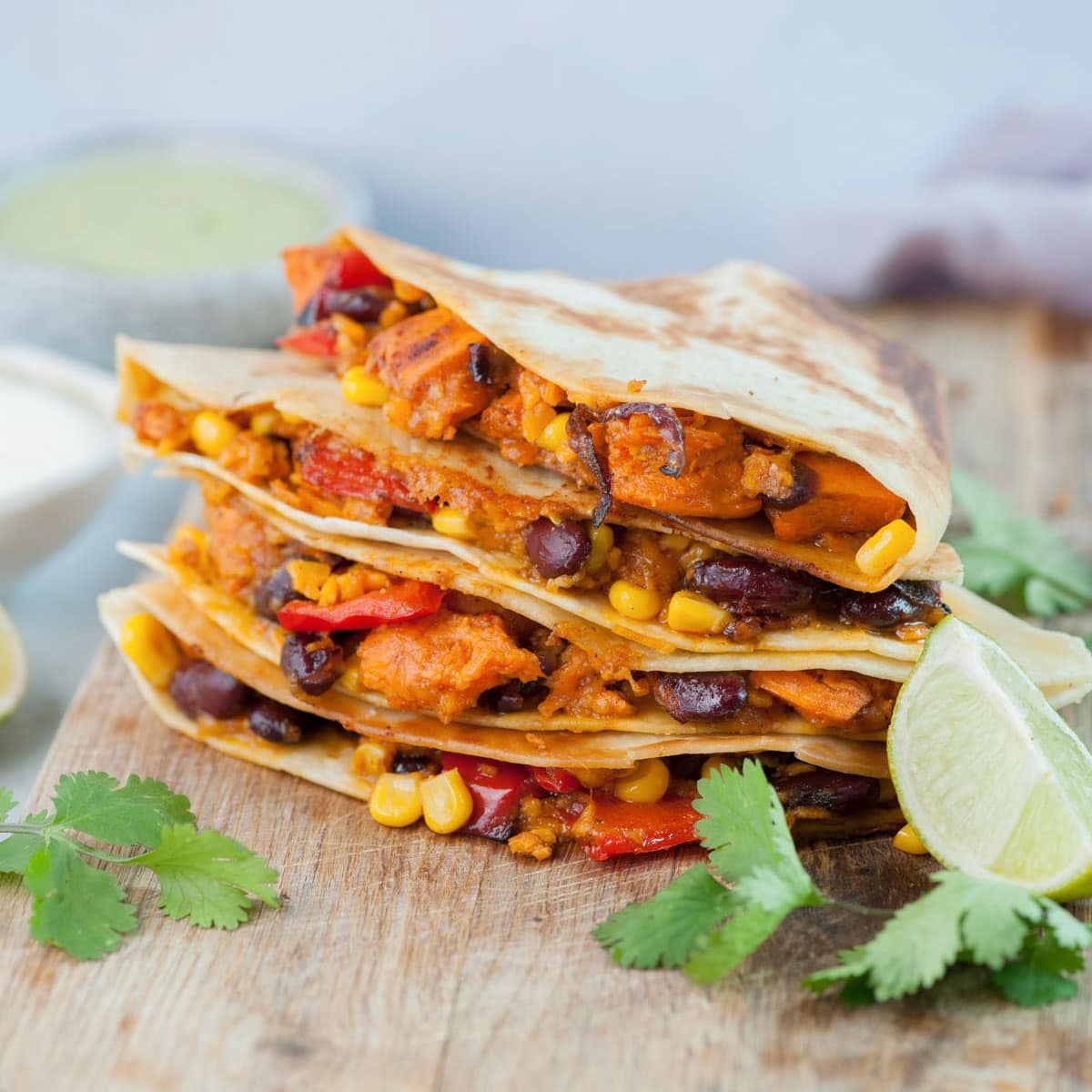 Vegetarian quesadillas on a wooden board.