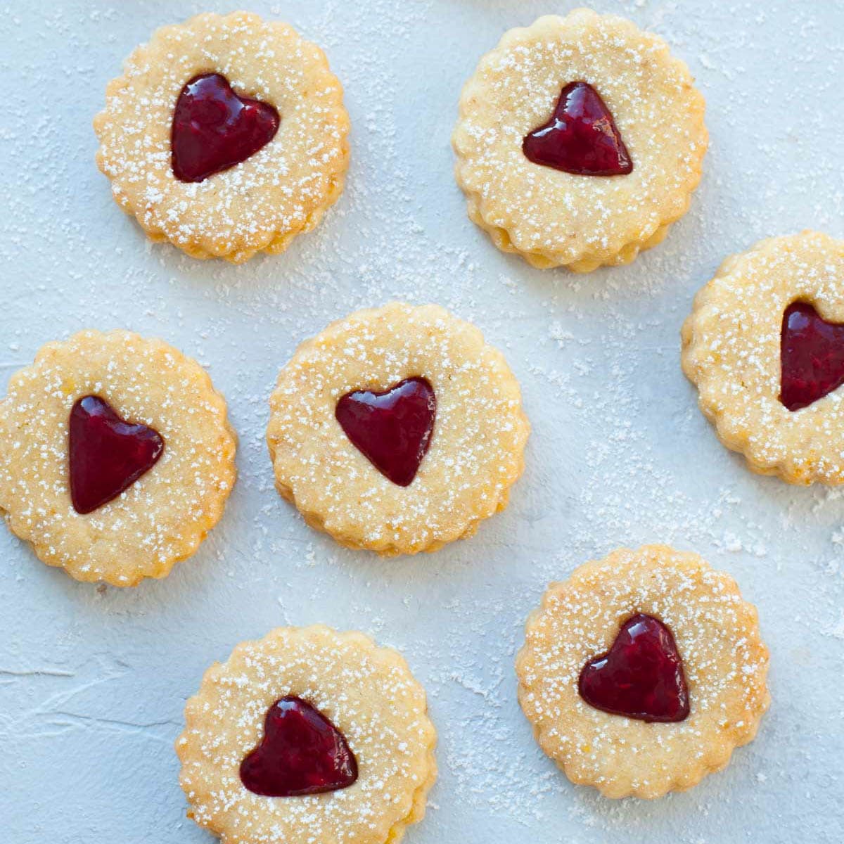 Linzer cookies on a blue background.