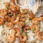 Cajun shrimp alfredo in a frying pan-.