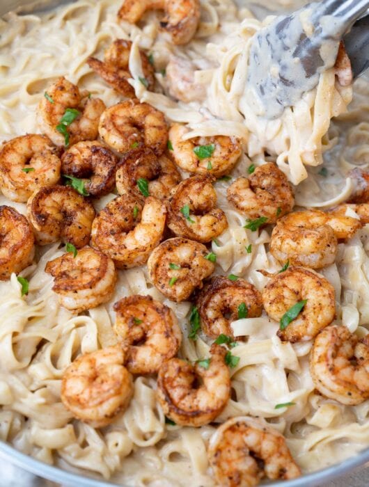 Cajun shrimp alfredo in a frying pan-.