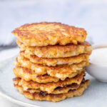 A stack of cauliflower fritters on a blue plate.