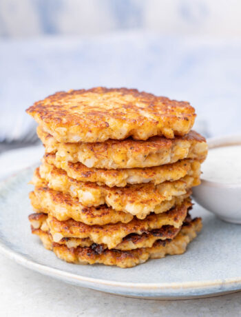 A stack of cauliflower fritters on a blue plate.