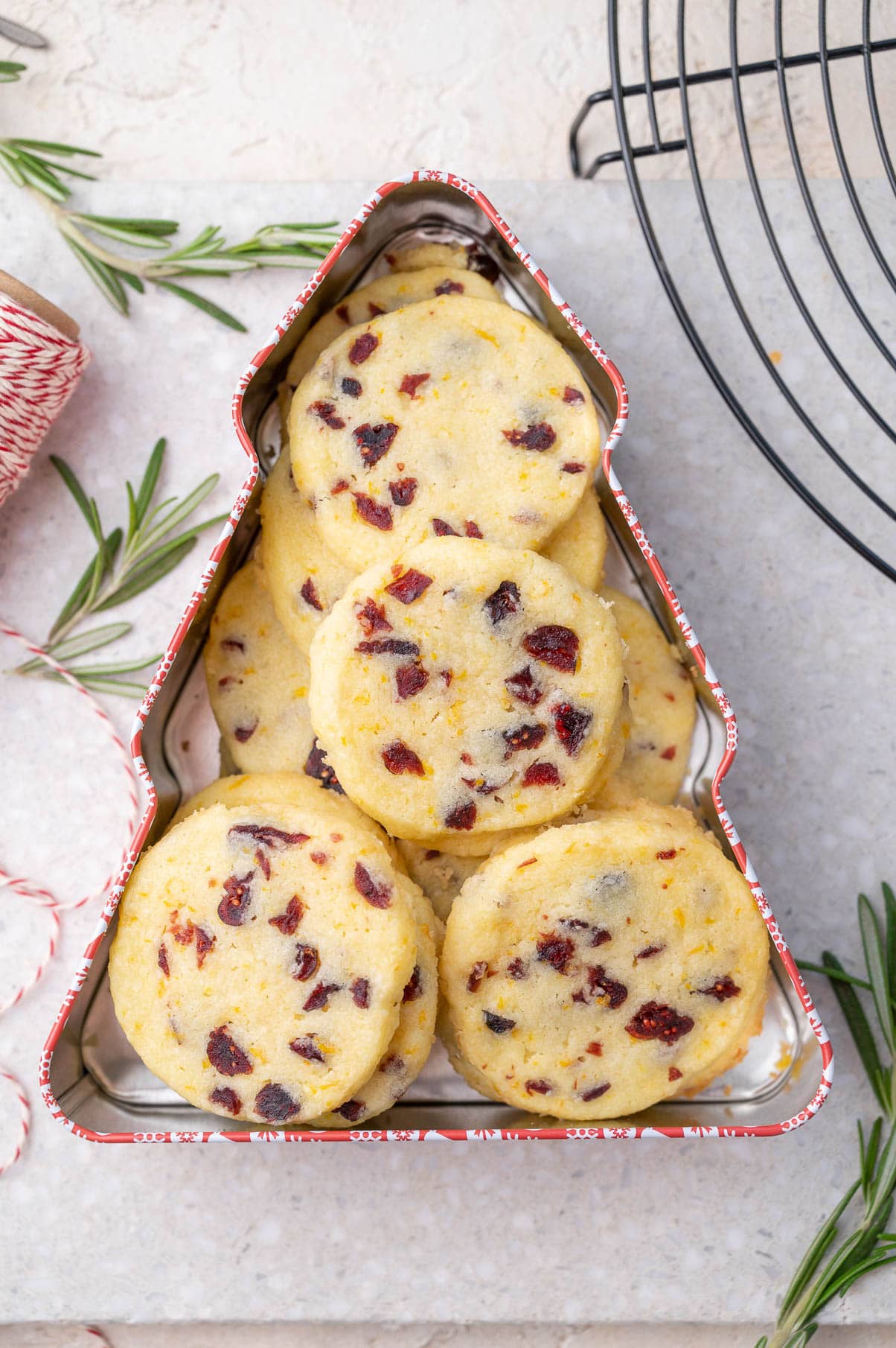 Cranberry shortbread cookies in a Christmas tree-shaped cookie tin.