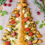 Puff pastry Christmas tree on a piece of parchment paper.