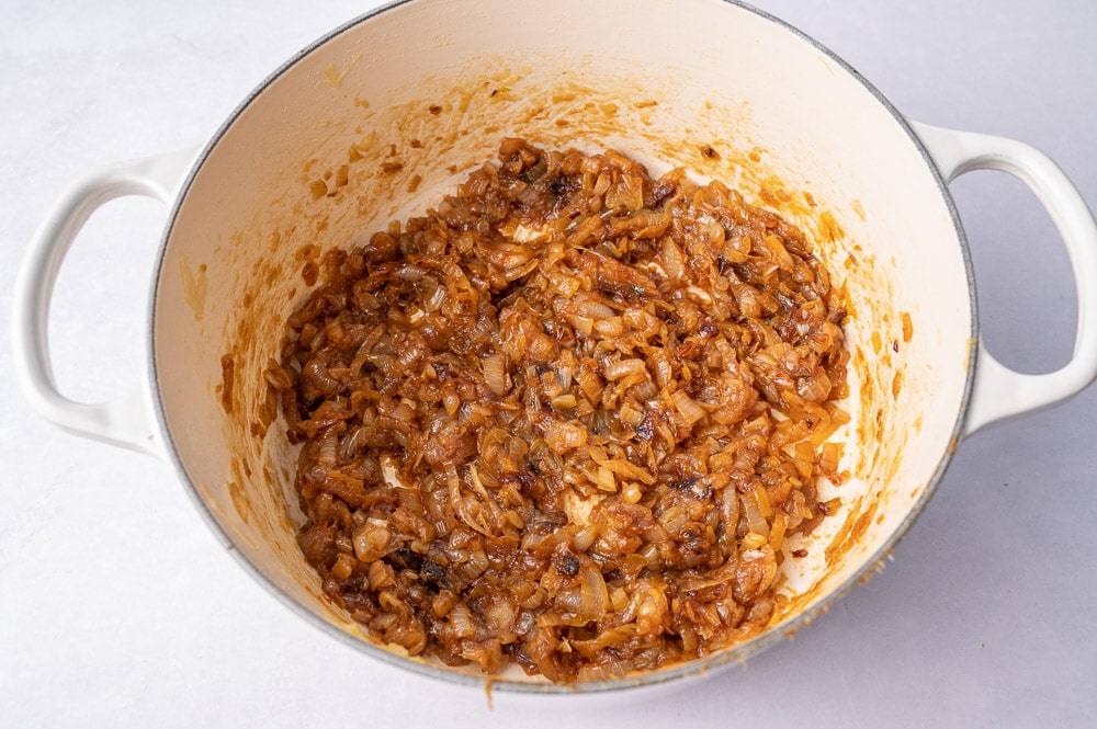 Caramelized onions in a white pot.