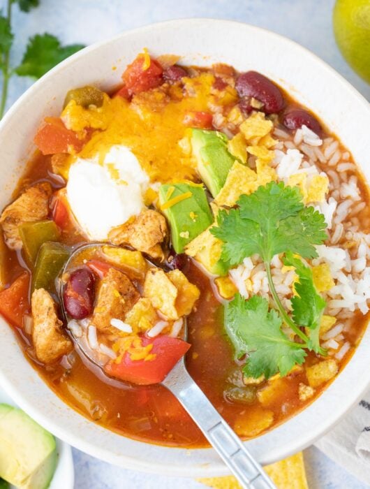 Chicken fajita soup in a white bowl.