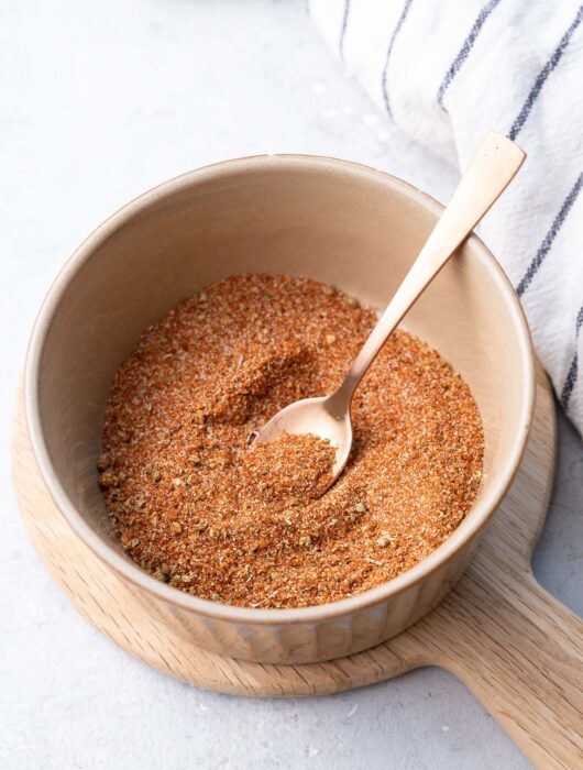 Fajita seasoning in a brown bowl.