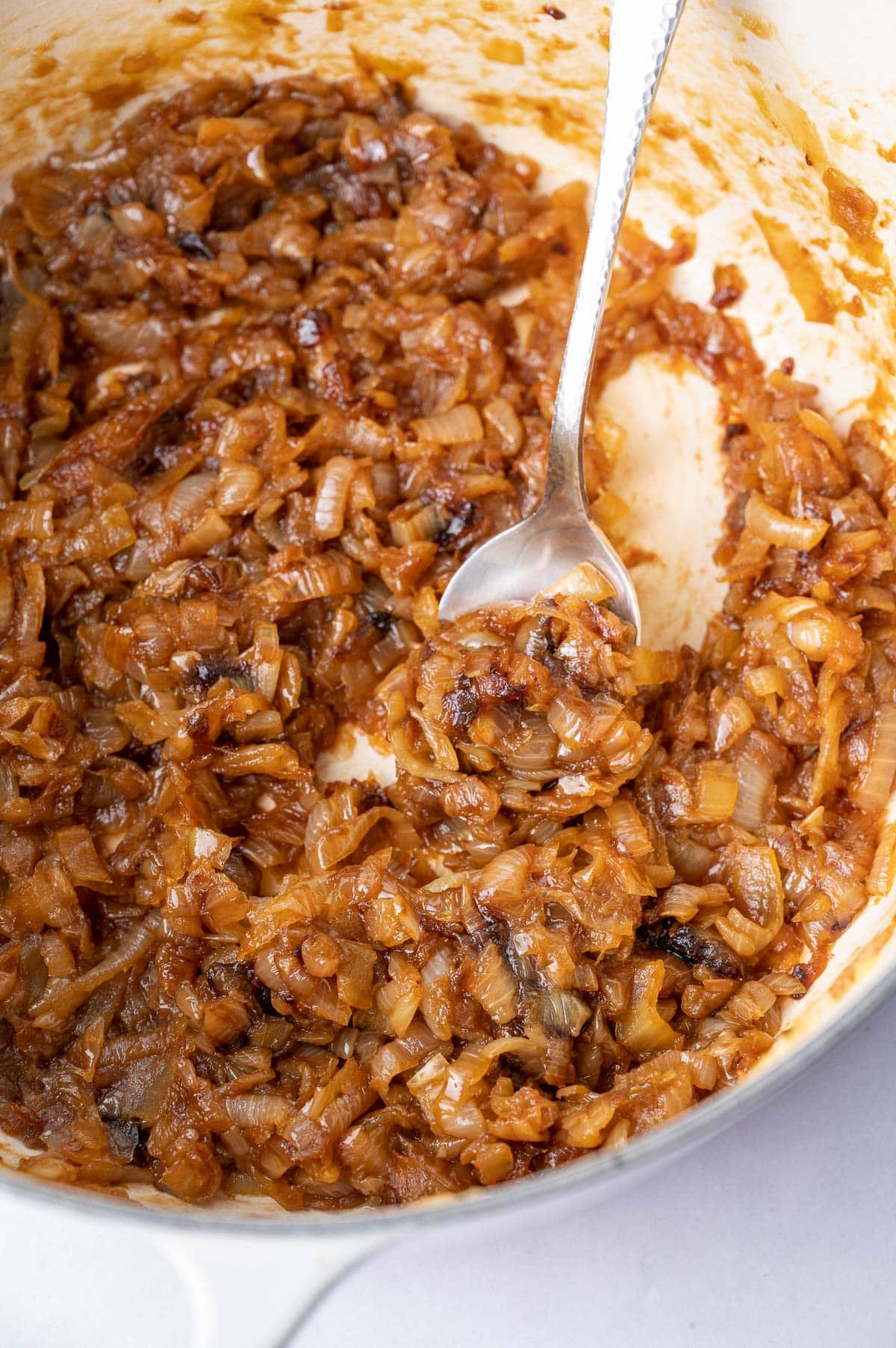 Caramelized onions in a white pot.