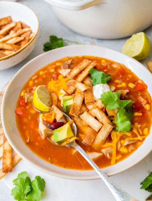 Turkey tortilla soup in a white bowl.