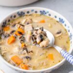 Turkey wild rice soup in a white-blue bowl.