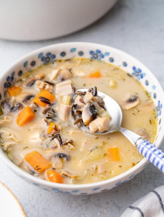 Turkey wild rice soup in a white-blue bowl.